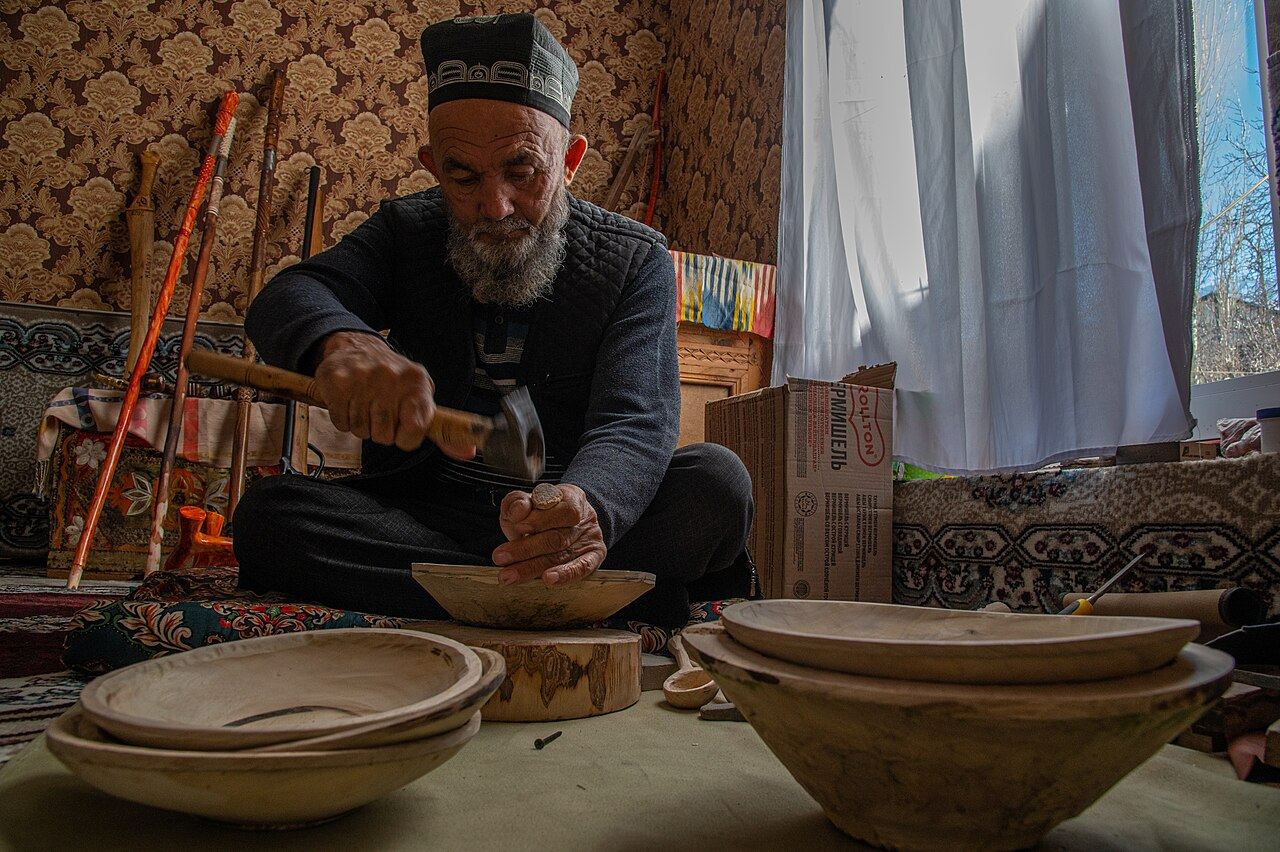 An Uzbek master woodcarver at work in his workshop.